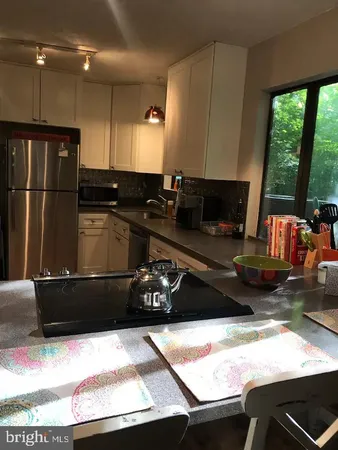 a kitchen with a stove and a refrigerator