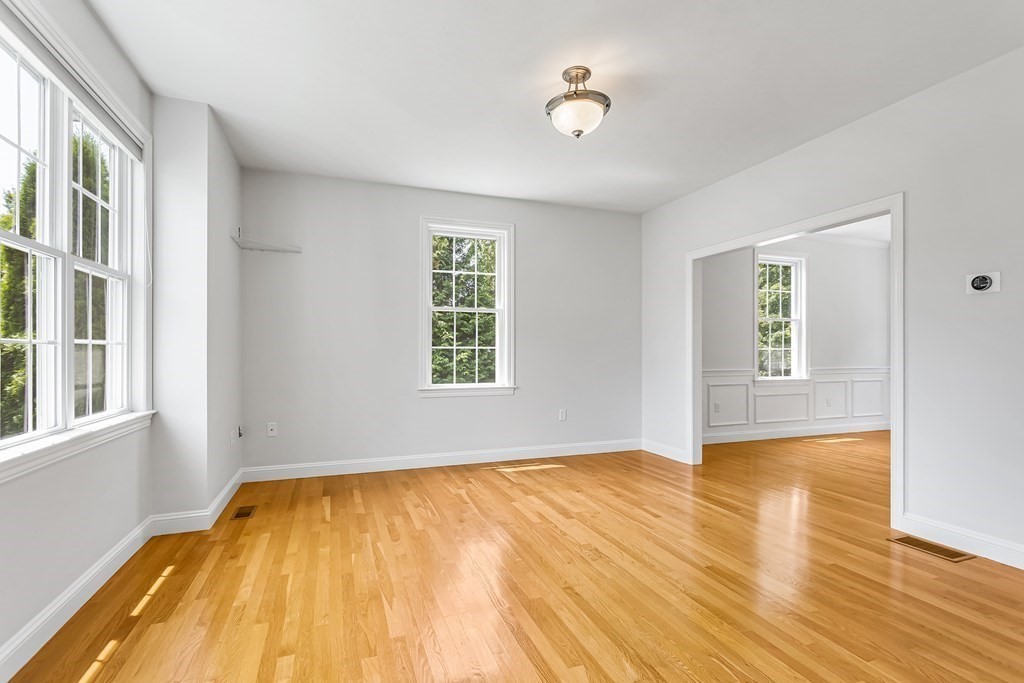 28 Brogden Road Ashland, MA 01721 - Photo 11 of 39 a view of empty room with wooden floor and fan