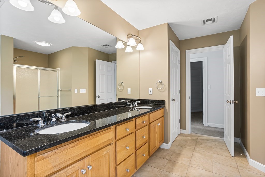 28 Brogden Road Ashland, MA 01721 - Photo 18 of 39 a bathroom with a granite countertop sink and a mirror