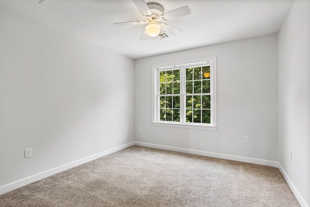 28 Brogden Road Ashland, MA 01721 - Photo 20 of 39 an empty room with a window and a fan