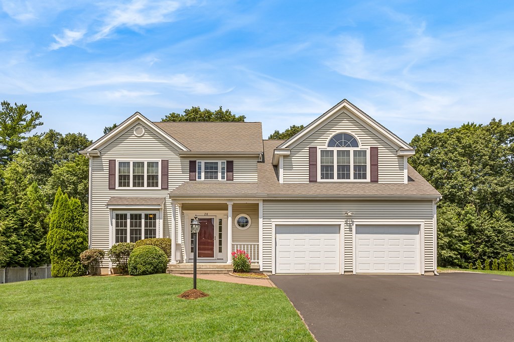 28 Brogden Road Ashland, MA 01721 - Photo 2 of 39 a front view of a house with a yard and garage