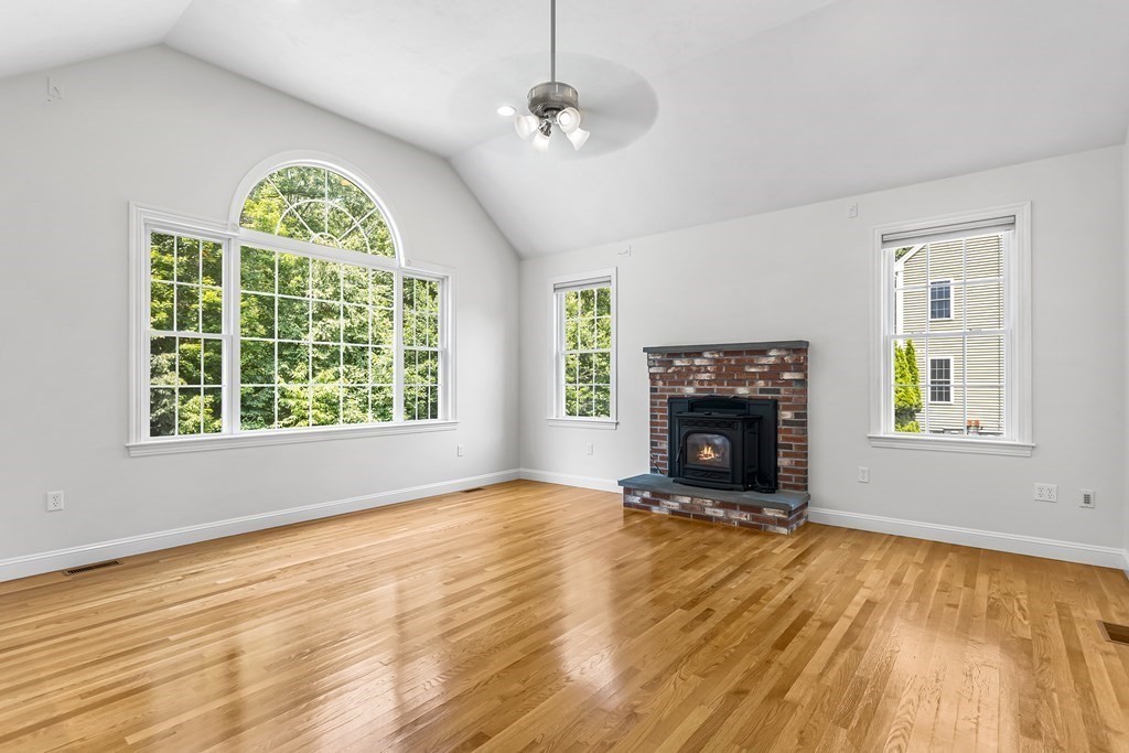28 Brogden Road Ashland, MA 01721 - Photo 5 of 39 wooden floor fireplace and windows in an empty room