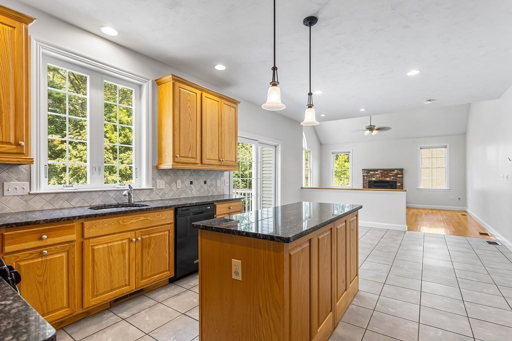 28 Brogden Road Ashland, MA 01721 - Photo 6 of 39 a kitchen with stainless steel appliances granite countertop a sink and a stove
