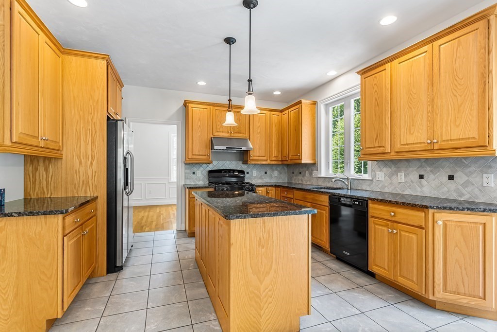 28 Brogden Road Ashland, MA 01721 - Photo 7 of 39 a kitchen with stainless steel appliances granite countertop a stove a sink and a refrigerator