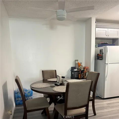a bedroom with a bed a desk and chair with wooden floor