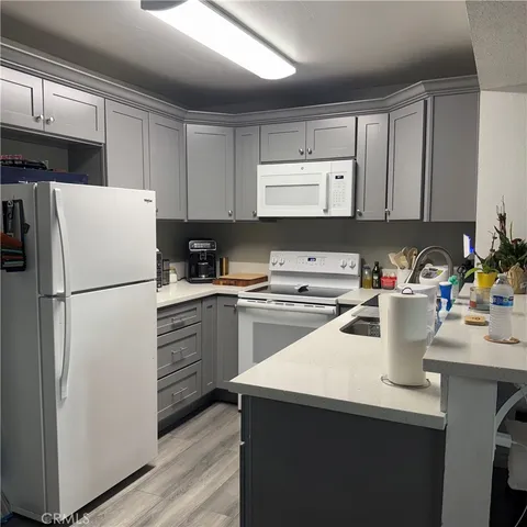a bedroom with a bed and a flat tv screen on wall