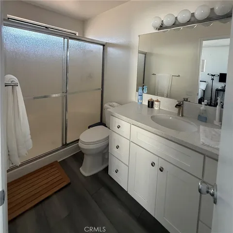 a view of a room with wooden floor and furniture