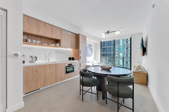 a kitchen with stainless steel appliances kitchen island granite countertop a sink and cabinets