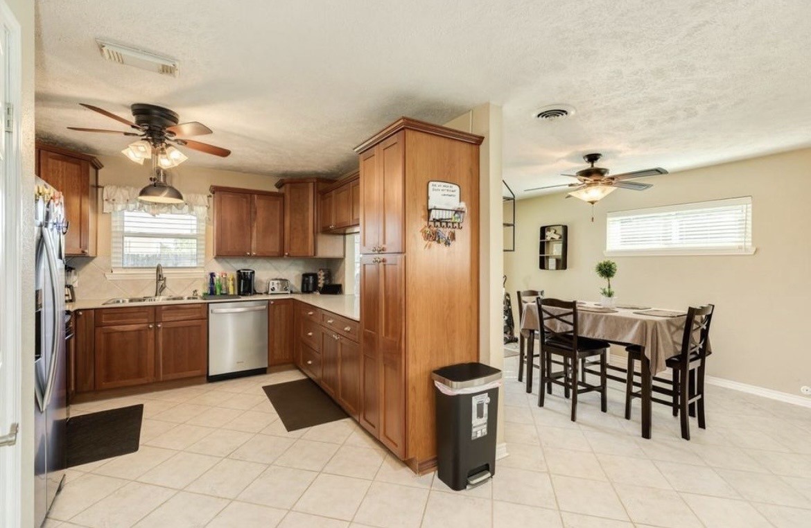 820 Perry Street Angleton, TX 77515 - Photo 16 of 26 a kitchen with stainless steel appliances granite countertop a refrigerator and a sink