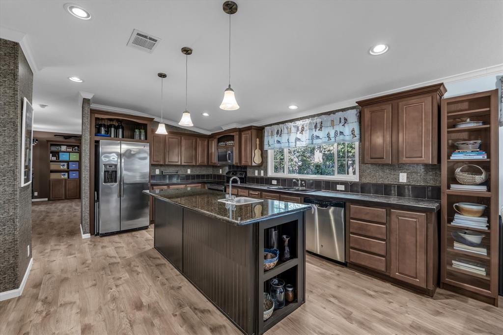 1745 Meixner Road Waco, TX 76705 - Photo 14 of 40 a kitchen with stainless steel appliances granite countertop a sink a stove and a refrigerator