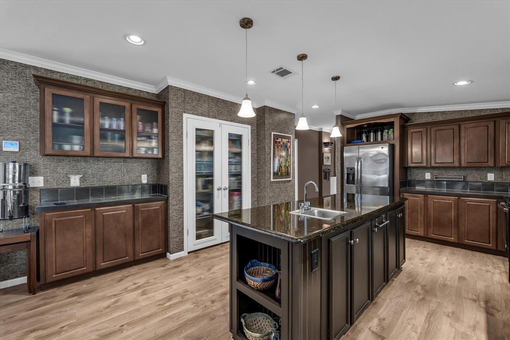 1745 Meixner Road Waco, TX 76705 - Photo 15 of 40 a kitchen with stainless steel appliances granite countertop a sink and wooden cabinets