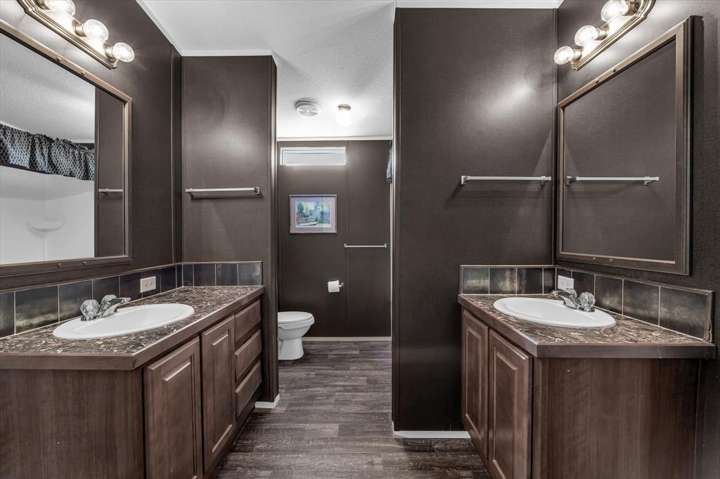 1745 Meixner Road Waco, TX 76705 - Photo 21 of 40 a bathroom with a double vanity sink and a mirror