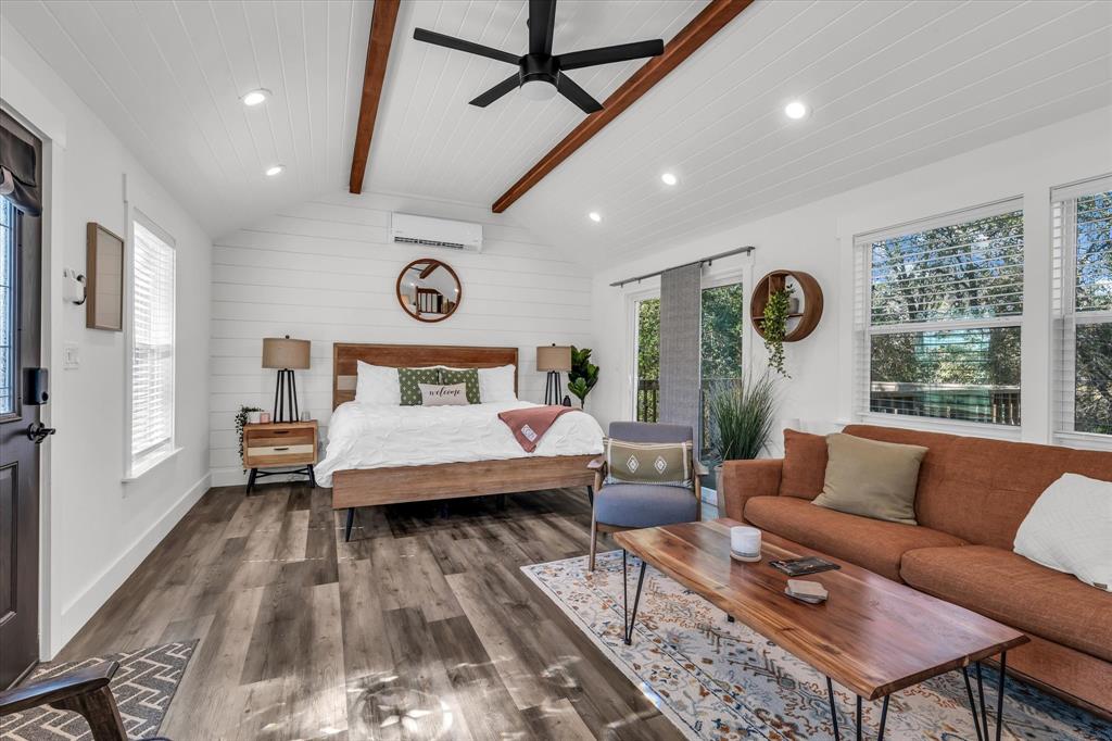 1745 Meixner Road Waco, TX 76705 - Photo 30 of 40 a spacious bedroom with a bed a couch and a large window