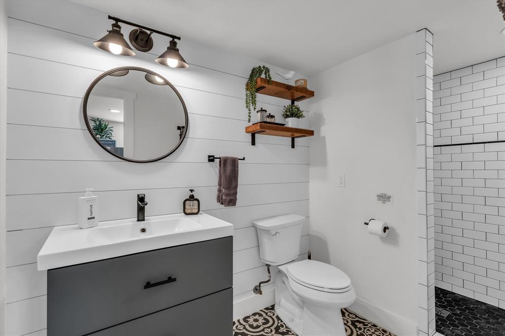 1745 Meixner Road Waco, TX 76705 - Photo 31 of 40 a bathroom with a toilet sink and mirror