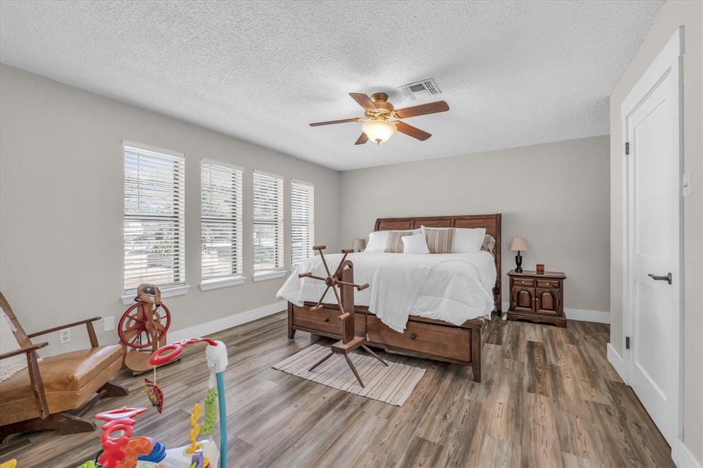 1745 Meixner Road Waco, TX 76705 - Photo 7 of 40 a bedroom with a bed and wooden floor