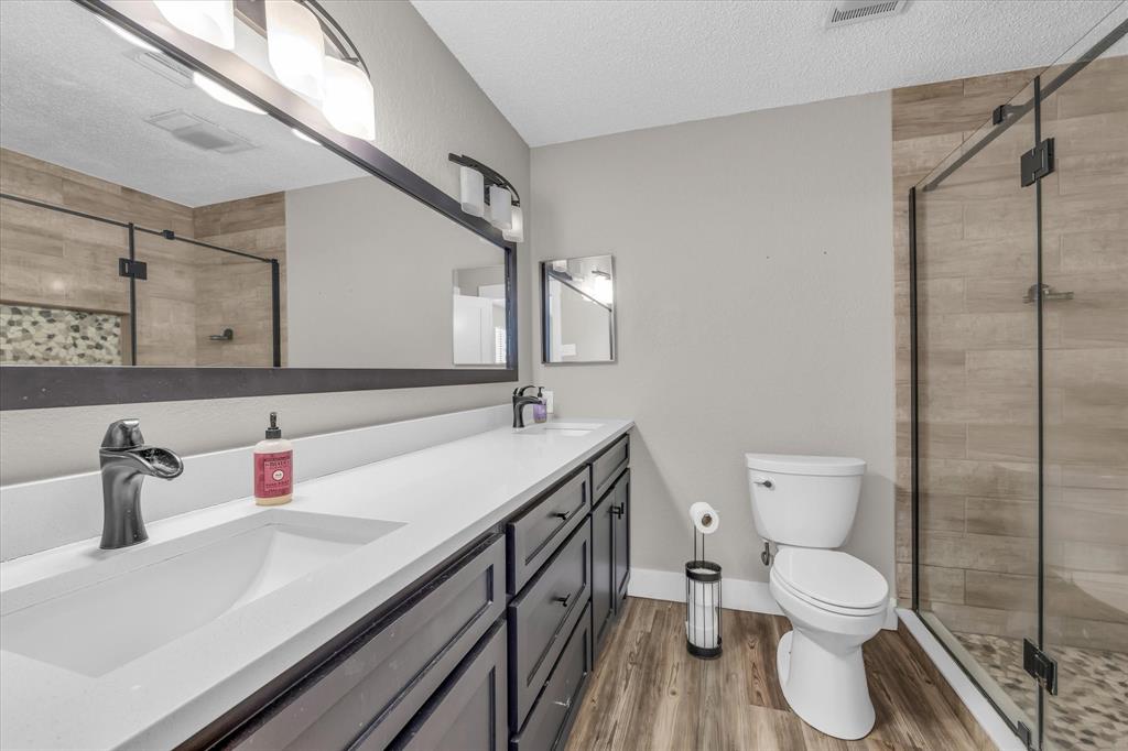 1745 Meixner Road Waco, TX 76705 - Photo 8 of 40 a bathroom with a toilet sink and mirror