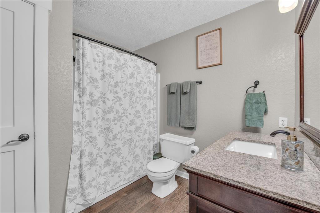 1745 Meixner Road Waco, TX 76705 - Photo 9 of 40 a bathroom with a granite countertop sink toilet and shower