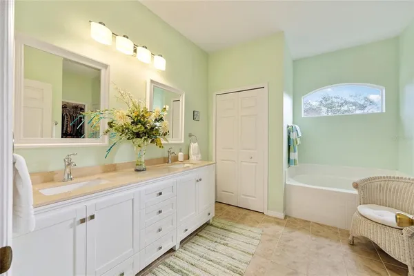 a bathroom with a tub sink and a mirror