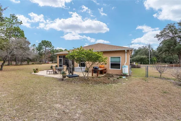 a view of a house with backyard porch and sitting area