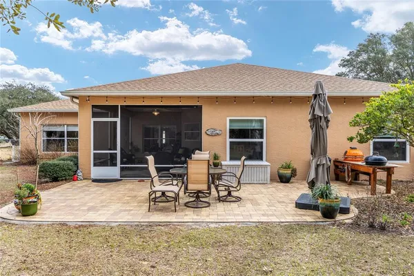 a view of a house with backyard porch and sitting area