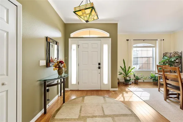 a view of a hallway to a livingroom with furniture