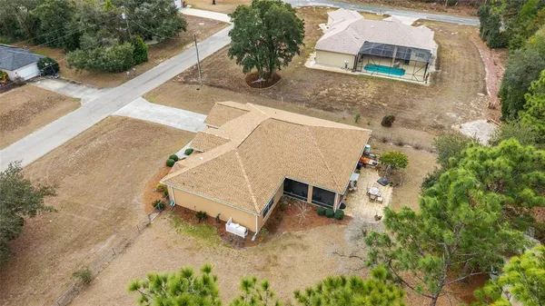 an aerial view of a house with a yard and sitting space