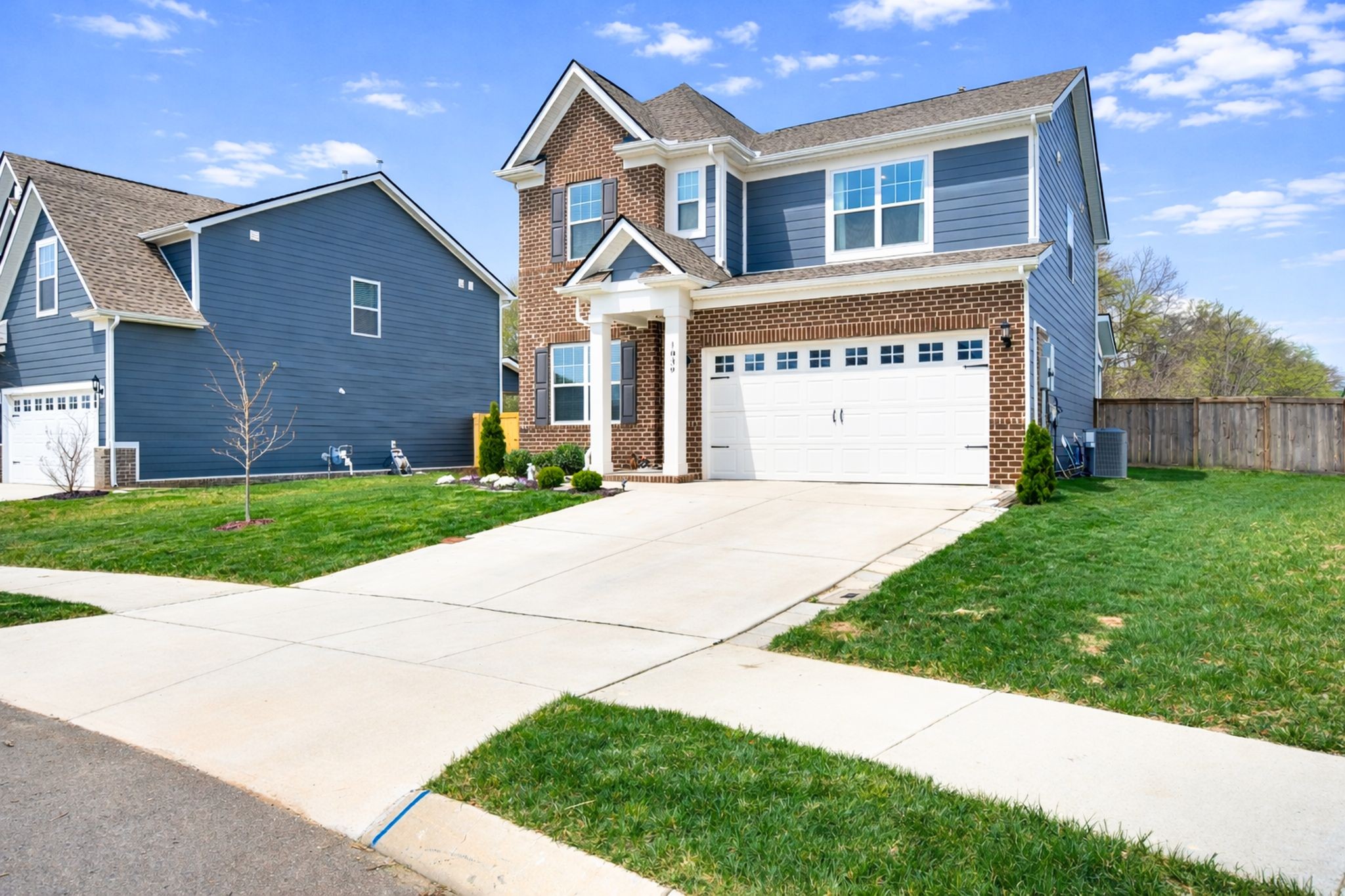 1039 Ewell Farm Drive Spring Hill, TN 37174 - Photo 2 of 70 a front view of a house with a yard and garage
