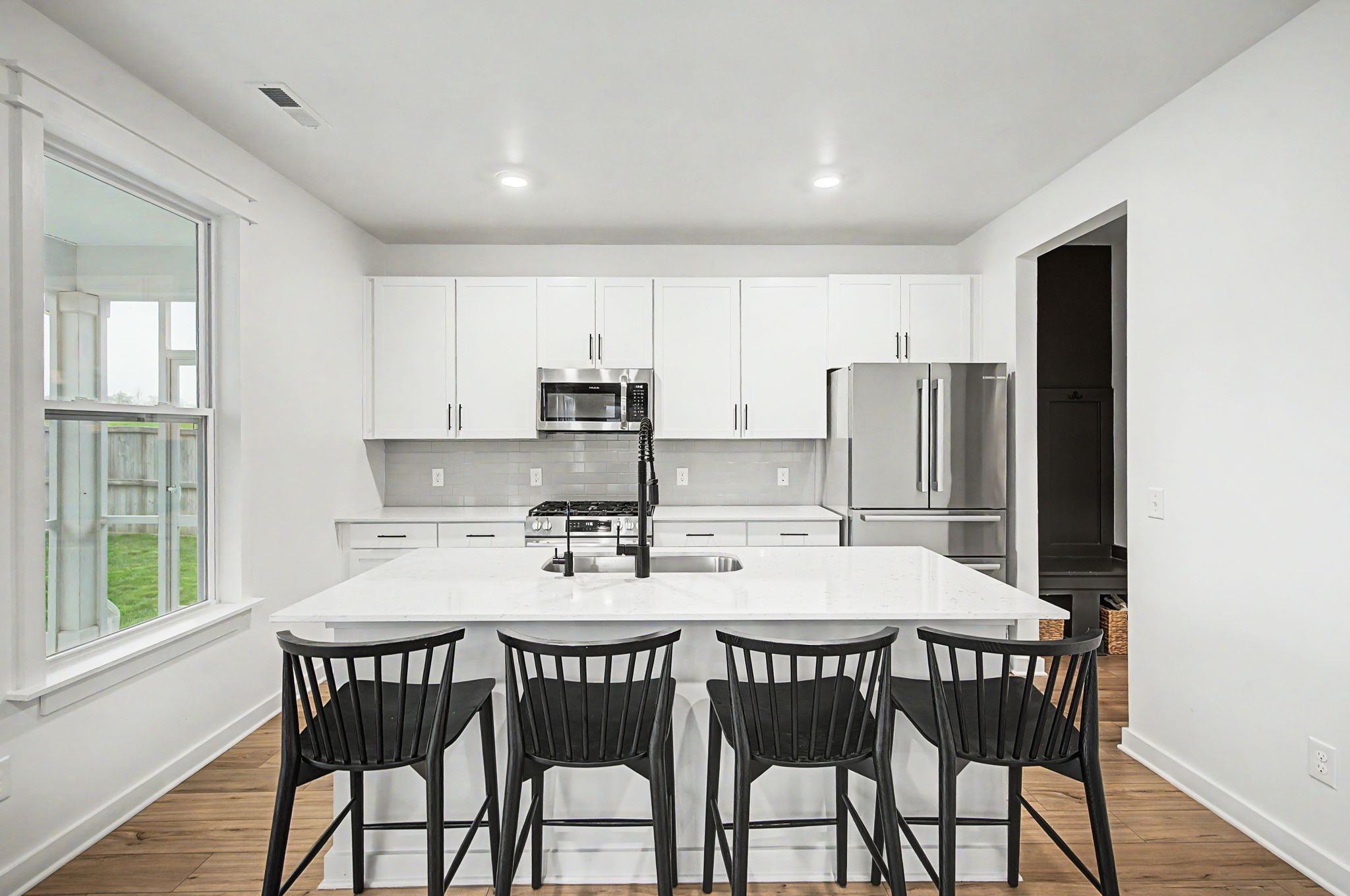 1039 Ewell Farm Drive Spring Hill, TN 37174 - Photo 22 of 70 a kitchen with stainless steel appliances kitchen island granite countertop a dining table chairs and refrigerator