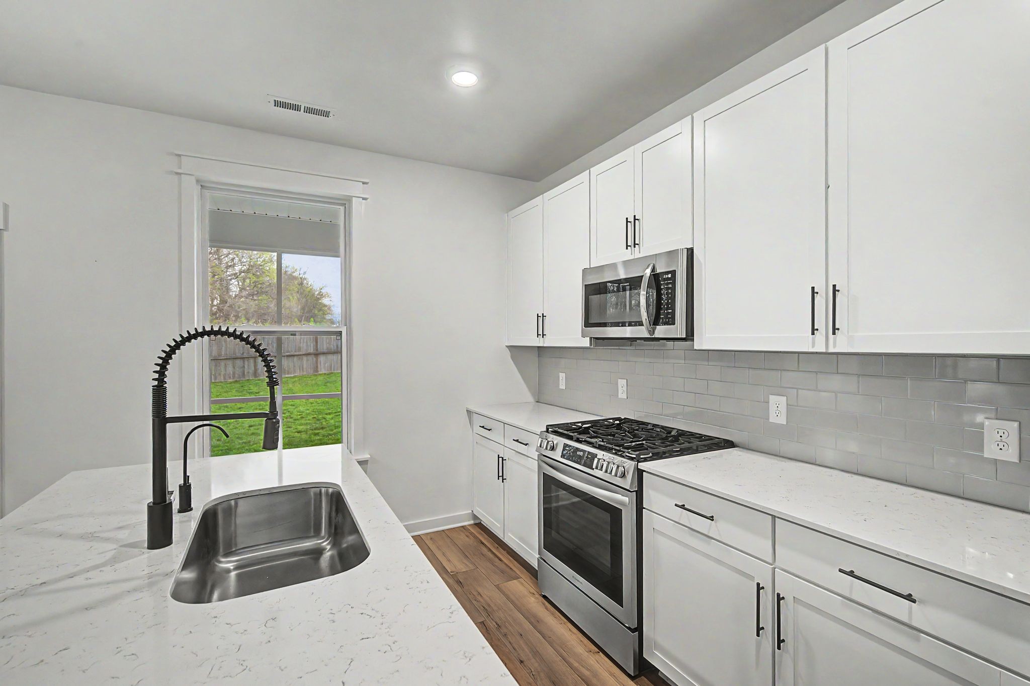 1039 Ewell Farm Drive Spring Hill, TN 37174 - Photo 27 of 70 a kitchen with sink a microwave and cabinets