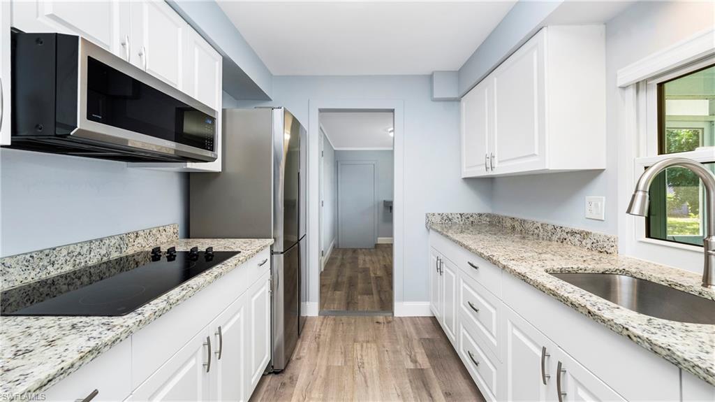 54 Hilo Court, Unit 54 Naples, FL 34112 - Photo 11 of 42 a kitchen with stainless steel appliances granite countertop a sink stove and refrigerator