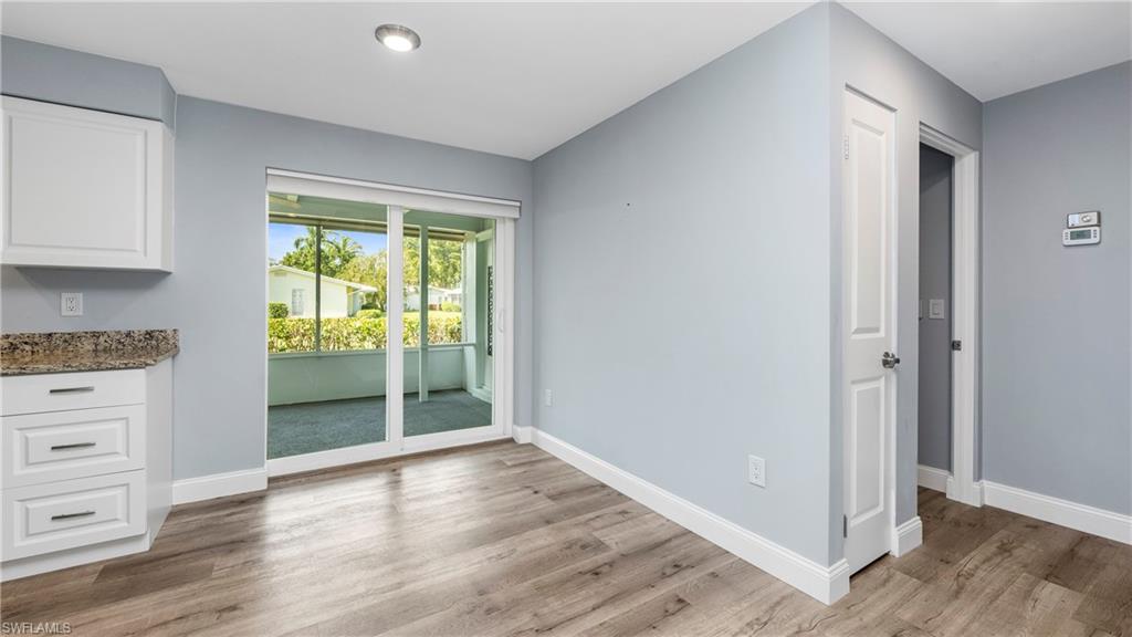 54 Hilo Court, Unit 54 Naples, FL 34112 - Photo 14 of 42 a view of kitchen and hall with wooden floor