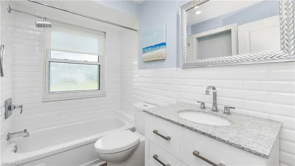 a view of walk in closet and bedroom