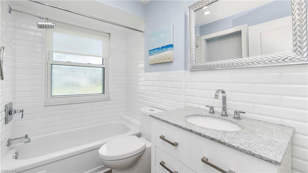 54 Hilo Court, Unit 54 Naples, FL 34112 - Photo 22 of 42 a bathroom with a granite countertop sink toilet and shower