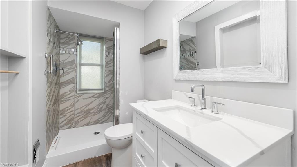 54 Hilo Court, Unit 54 Naples, FL 34112 - Photo 23 of 42 a bathroom with a sink toilet and shower