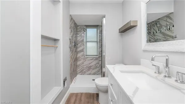 a bathroom with a sink toilet and shower