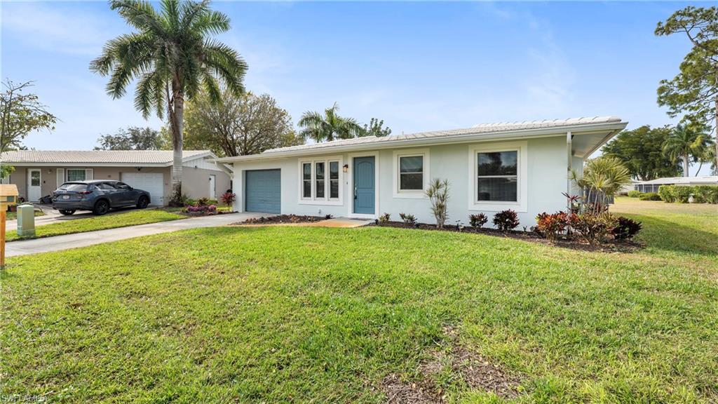 54 Hilo Court, Unit 54 Naples, FL 34112 - Photo 31 of 42 a front view of house with yard and green space