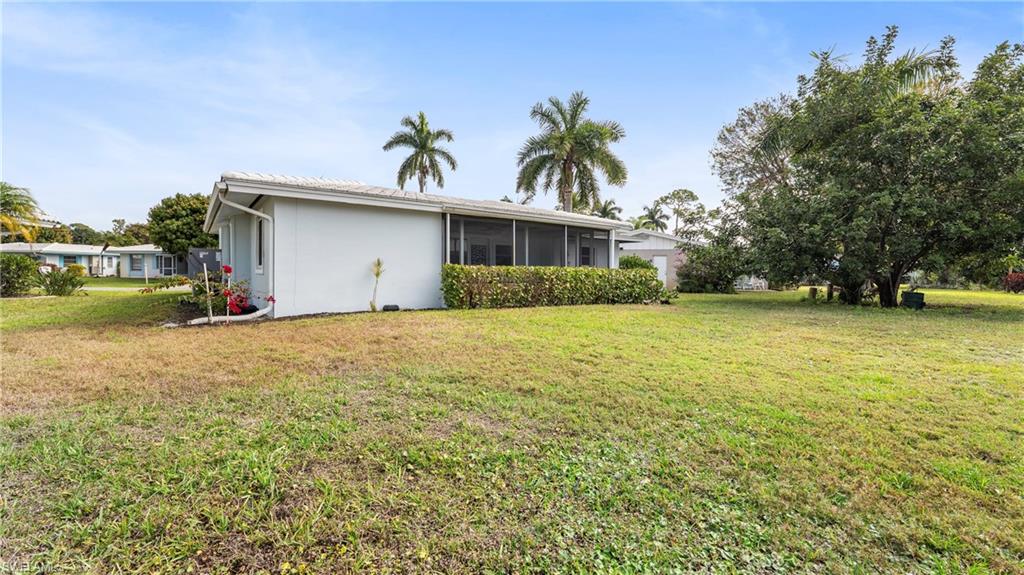 54 Hilo Court, Unit 54 Naples, FL 34112 - Photo 32 of 42 a front view of a house with garden
