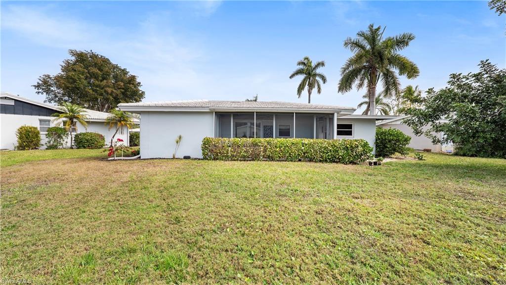 54 Hilo Court, Unit 54 Naples, FL 34112 - Photo 33 of 42 a house view with a garden space