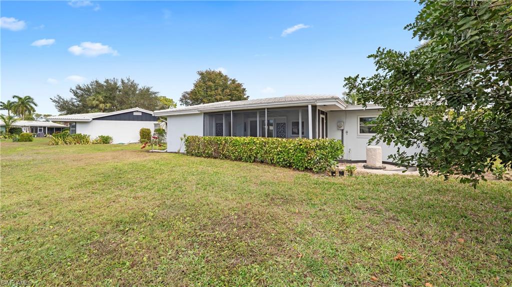 54 Hilo Court, Unit 54 Naples, FL 34112 - Photo 34 of 42 a house view with a garden space
