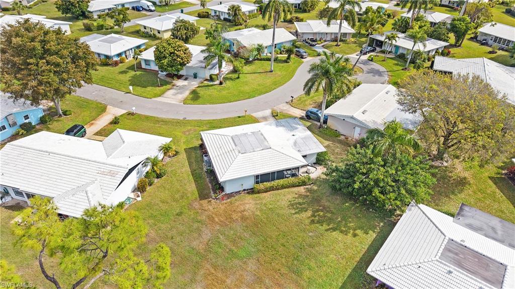 54 Hilo Court, Unit 54 Naples, FL 34112 - Photo 36 of 42 an aerial view of a house with swimming pool and large trees