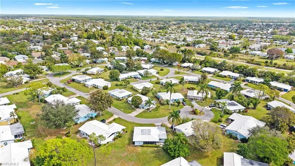 an aerial view of a residential houses with city view