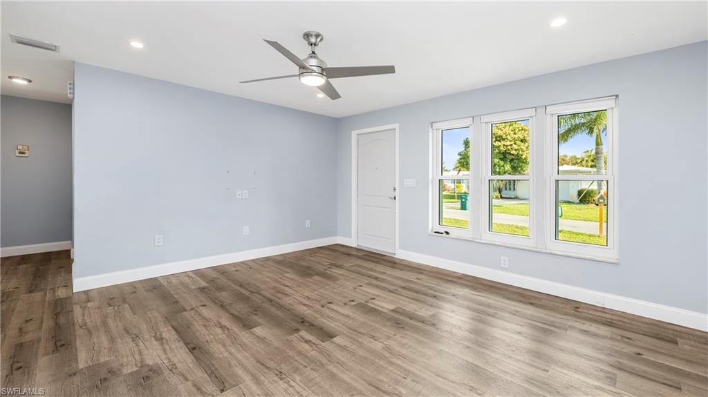 54 Hilo Court, Unit 54 Naples, FL 34112 - Photo 8 of 42 wooden floor in an empty room with a window