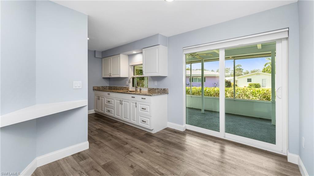 54 Hilo Court, Unit 54 Naples, FL 34112 - Photo 9 of 42 a kitchen with granite countertop a refrigerator and a sink