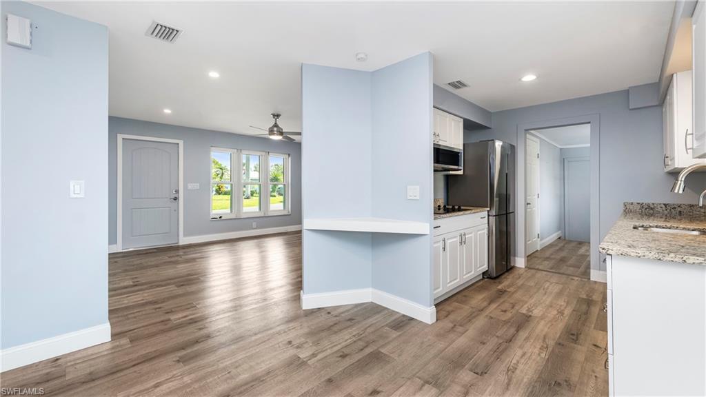 54 Hilo Court, Unit 54 Naples, FL 34112 - Photo 42 of 42 a view of a kitchen cabinets and wooden floor