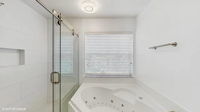 a bathroom with a bathtub and shower