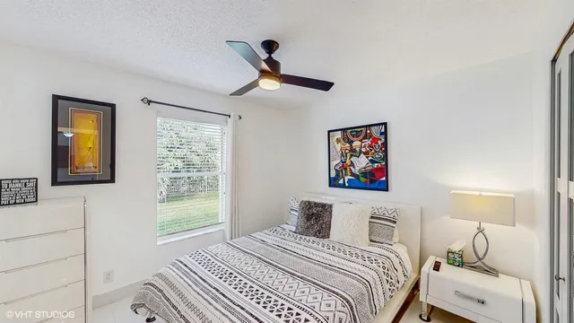 a bedroom with a bed and a window