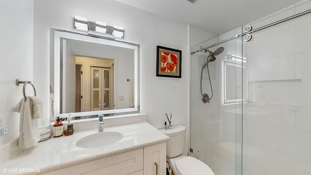 a bathroom with a sink toilet and shower