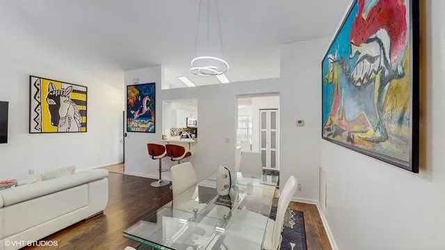 a living room with furniture and painting on the wall