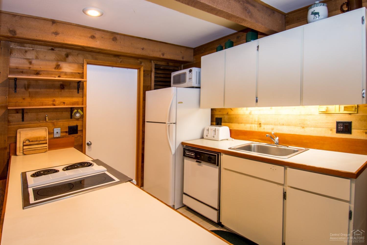 13 Ranch Cabin Road Sunriver, OR 97707 - Photo 8 of 21 a kitchen with a refrigerator and a sink
