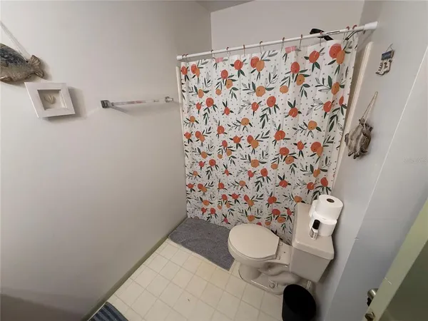 a bathroom with a sink toilet and shower curtain